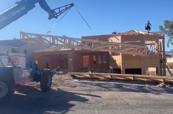 setting trusses on new home with forklift